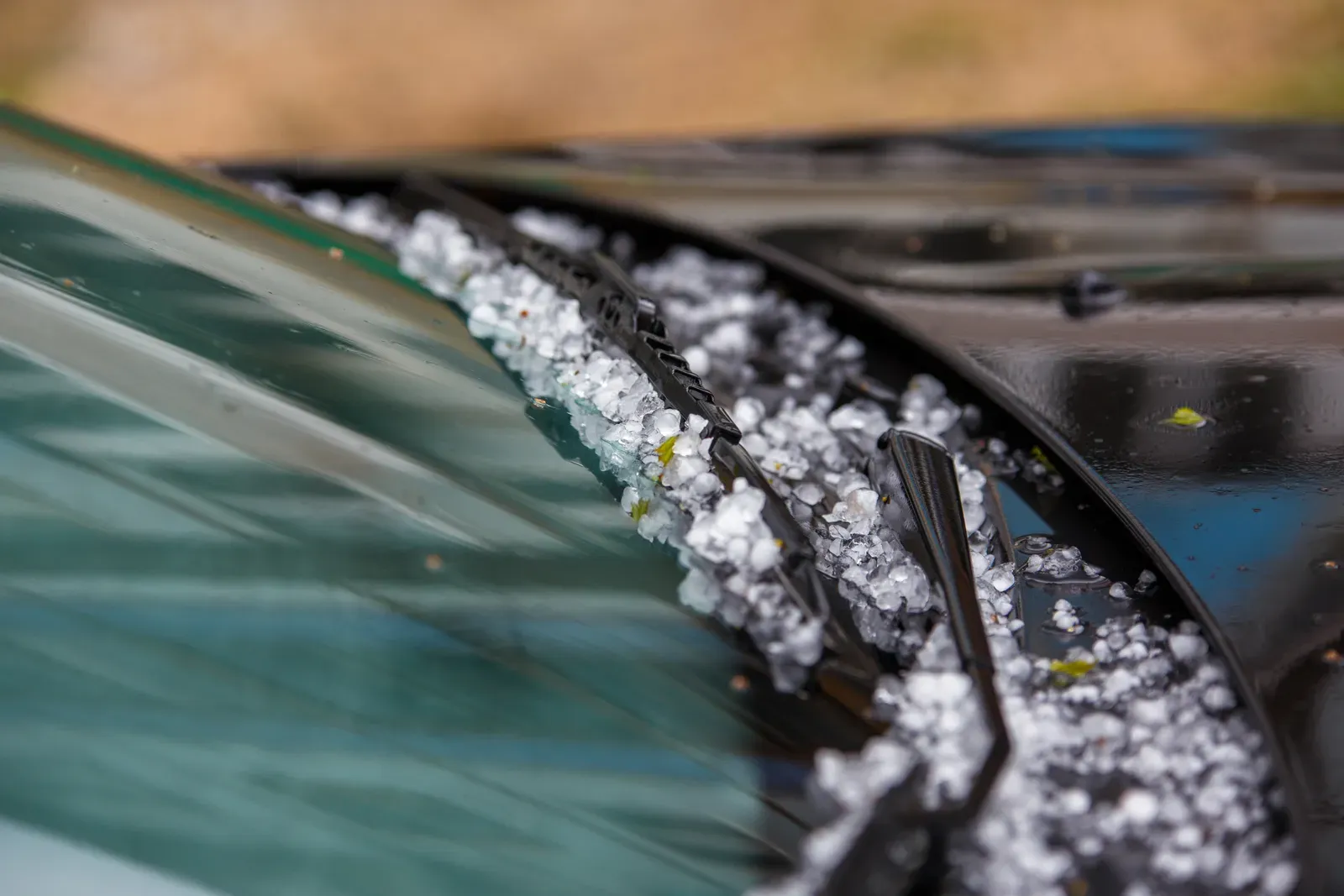Zahlreiche Hageldellen auf der Motorhaube eines Autos